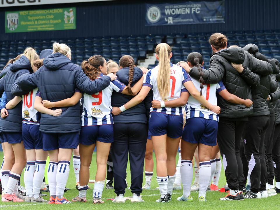 An image of the Albion Women's team in a huddle