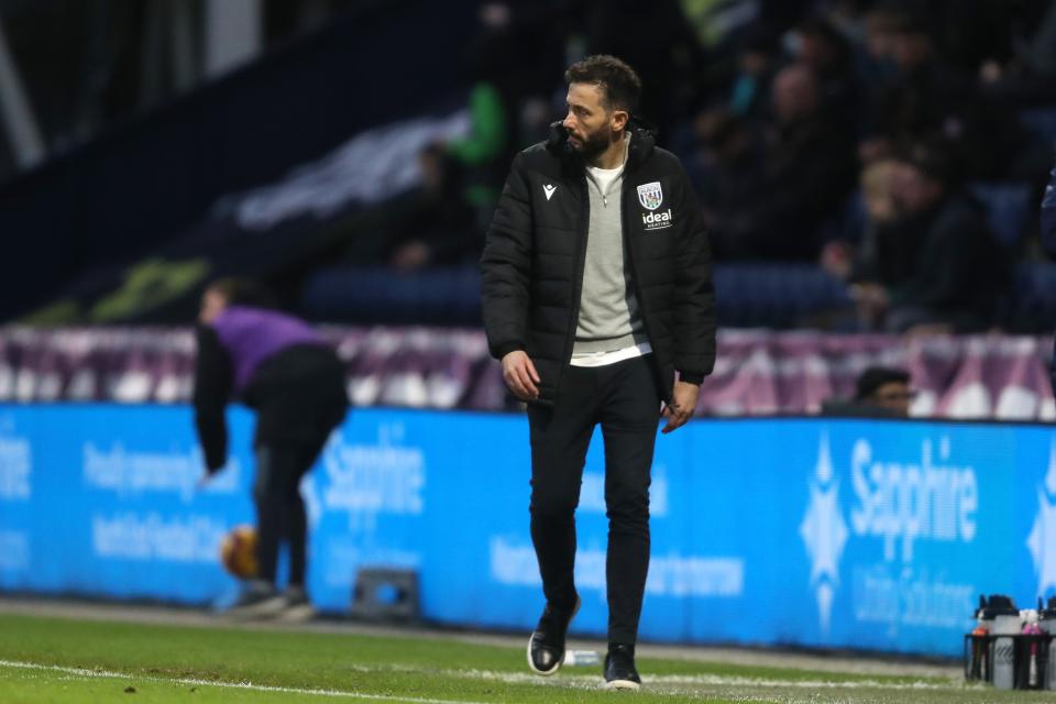 Carlos Corberán walking down the touchline at Deepdale