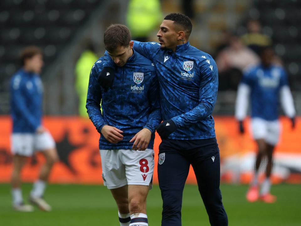 An image of Karlan Grant with his arm around Jayson Molumby