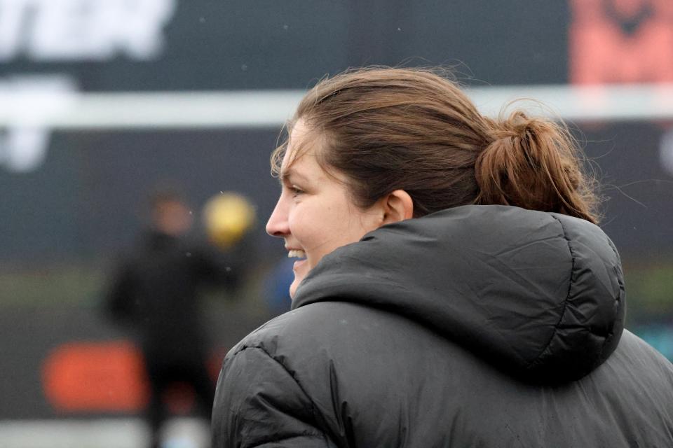 Siobhan Hodgetts-Still on the side of the pitch smiling 