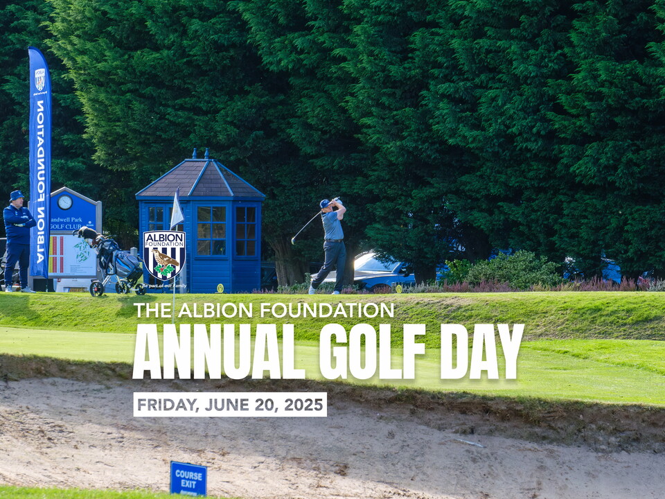 Golfer teeing off with greenery in the background.