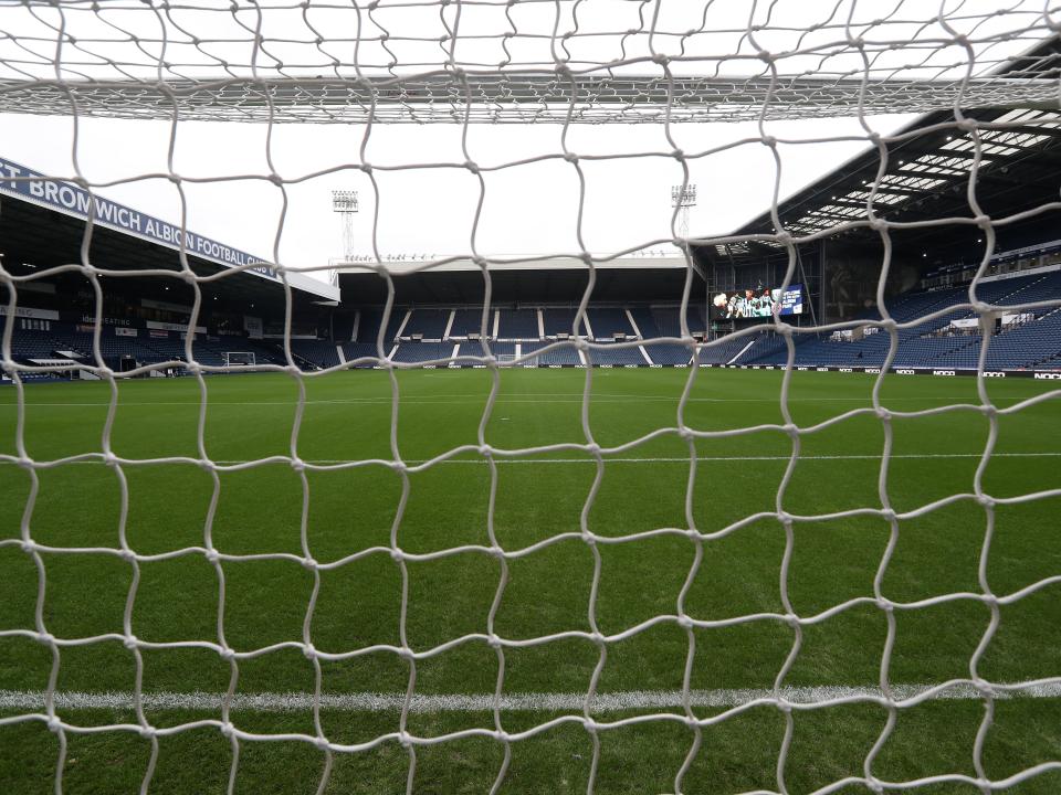 An image of The Hawthorns from the Smethwick End through a goal net