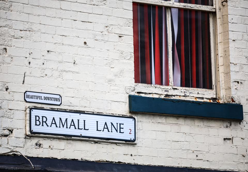 A road sign saying Bramall Lane on the side of a house 