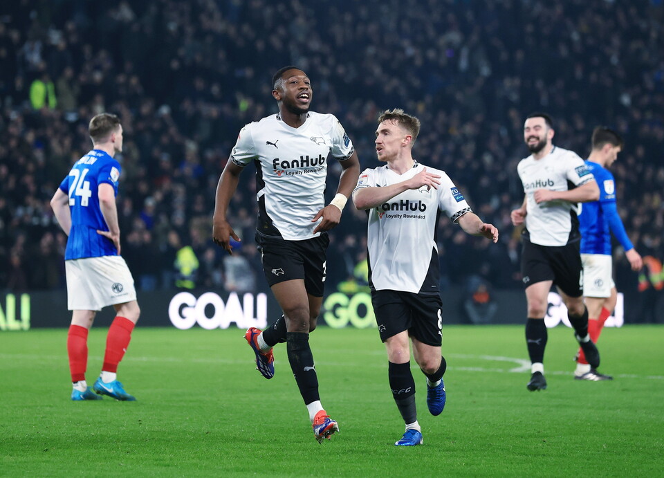Derby County players celebrate a goal scored against Portsmouth 