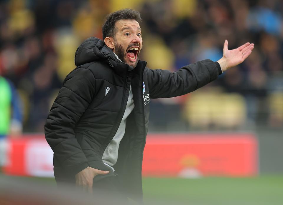 Carlos Corberán with his arm out to the side on the side of the pitch at Watford 