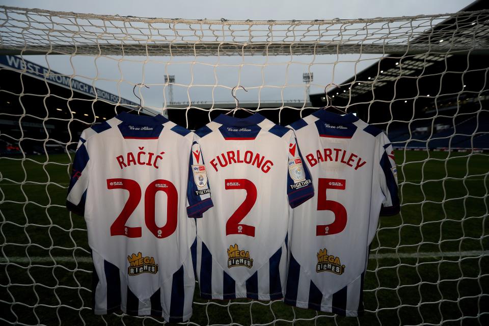 An image of Racic, 20, Furlong, 2, and Bartley, 5, shirts hanging up in the goal net at The Hawthorns