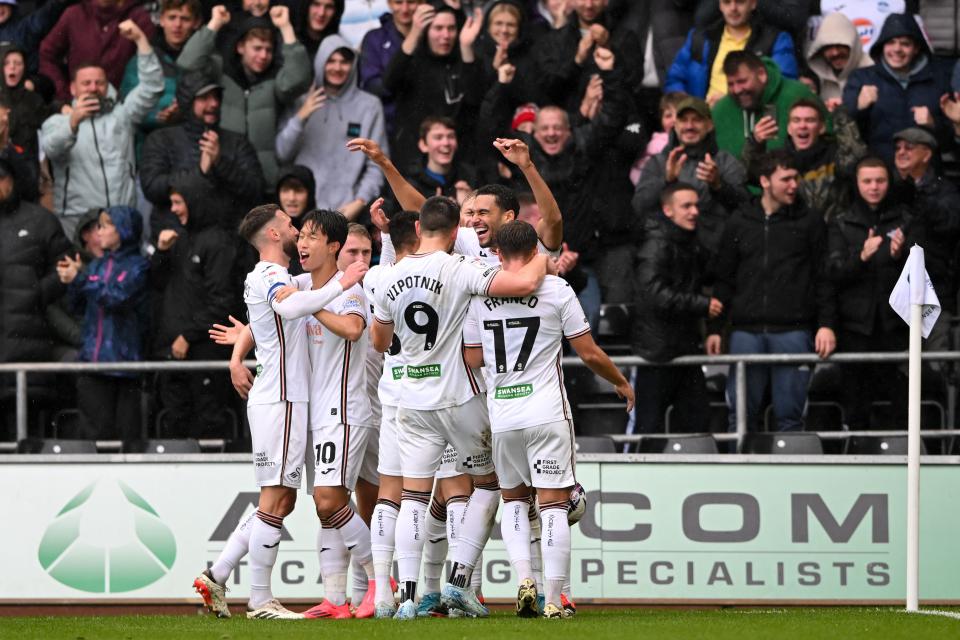 A general view of several Swansea City players celebrating a goal
