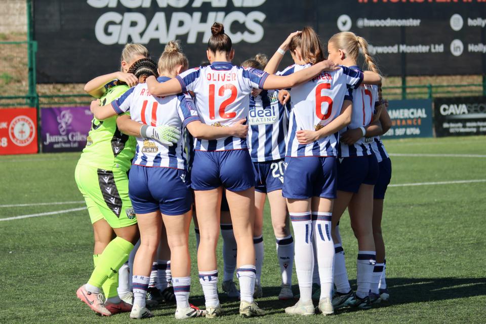 Albion Women in a team talk.