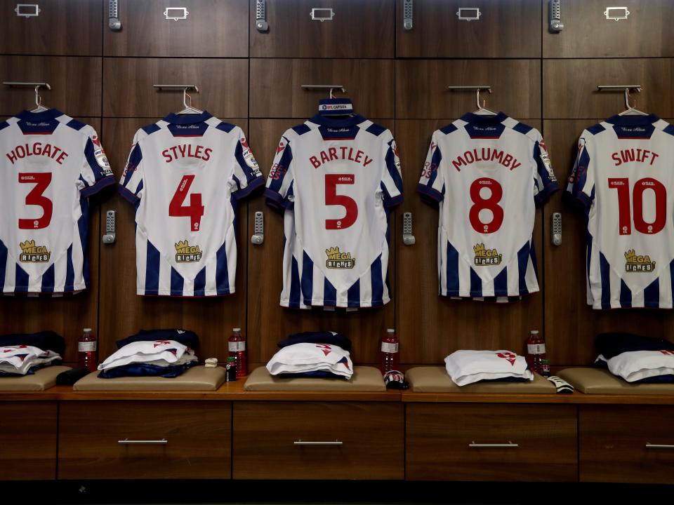 An image of Albion shirts hanging up in the away dressing room at Carrow Road