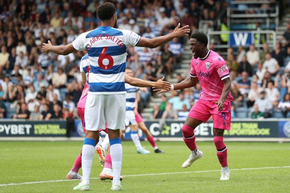 Josh Maja in the pink away kit celebrates scoring at QPR 