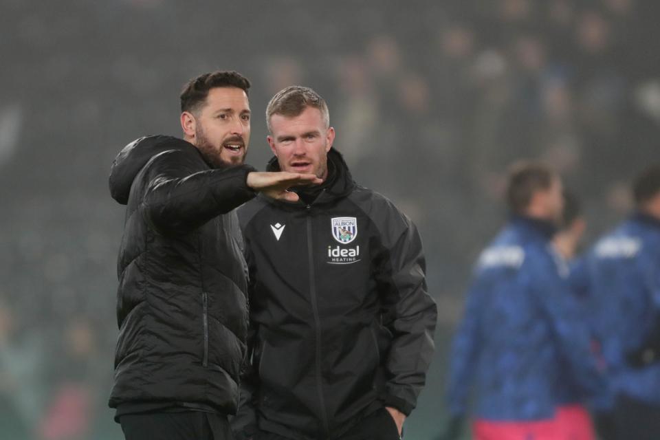Damia Abella and Chris Brunt on the side of the pitch at Pride Park talking 