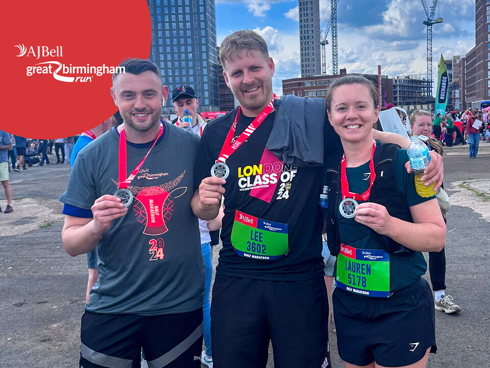 Three participants holding their medals.