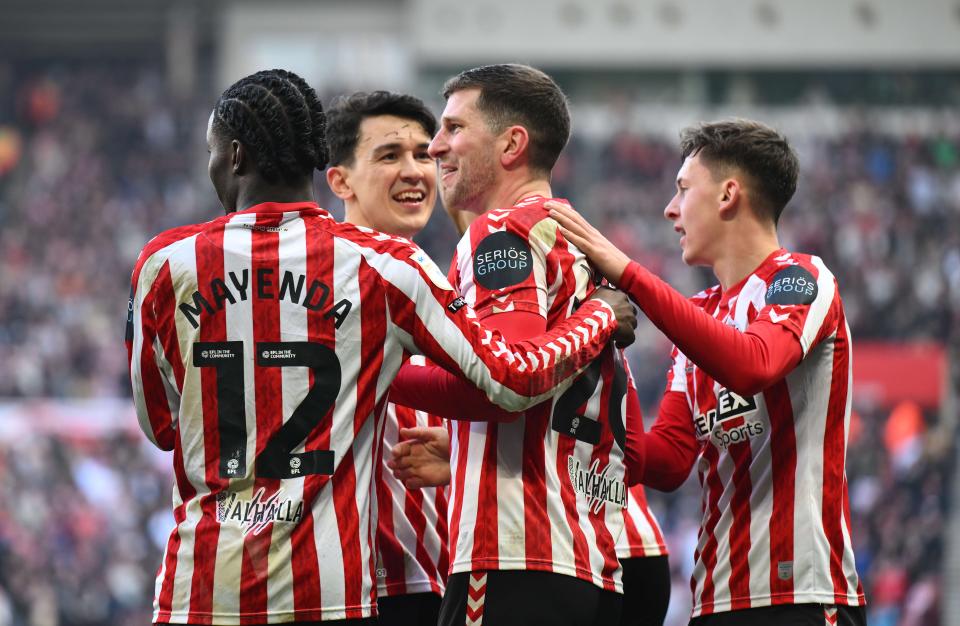 Several Sunderland players celebrate a goal scored in their home kit 