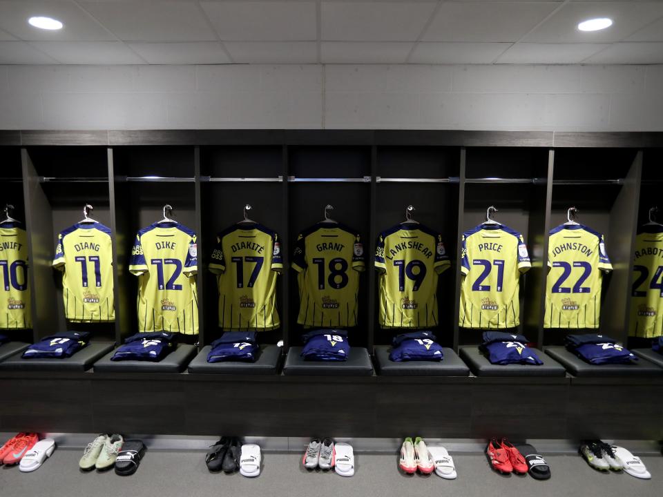 An image of the dressing room with yellow Albion shirts hanging in it