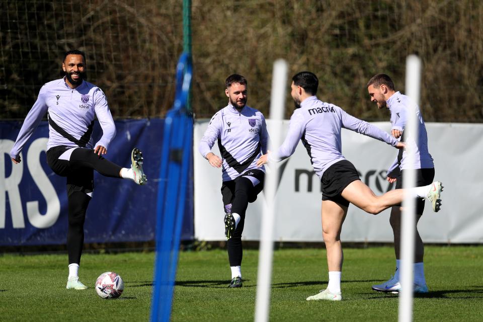 Adam Armstrong warming up before a training session with three Albion team-mates