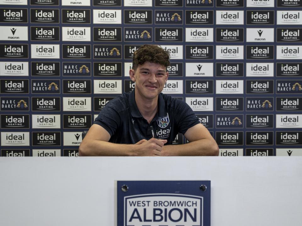 A photo of Albion U18s defender Noah DuPont signing a contract