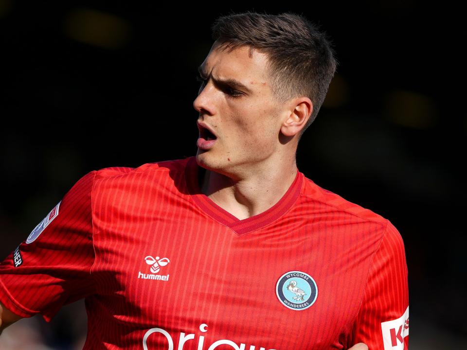 A photo of Caleb Taylor in the red away kit of loan club Wycombe