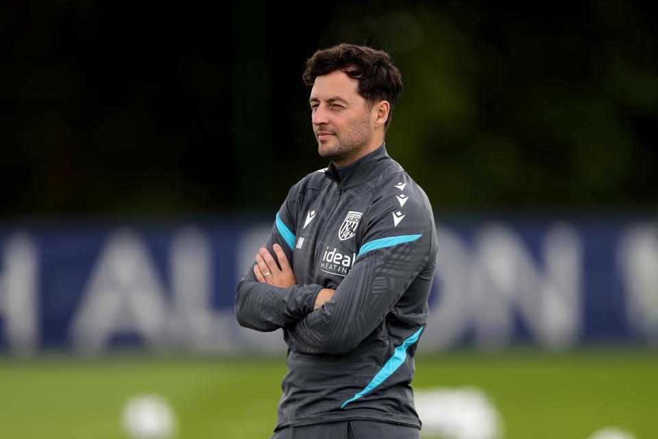 Ryan Mason folding his arms while watching over a training session