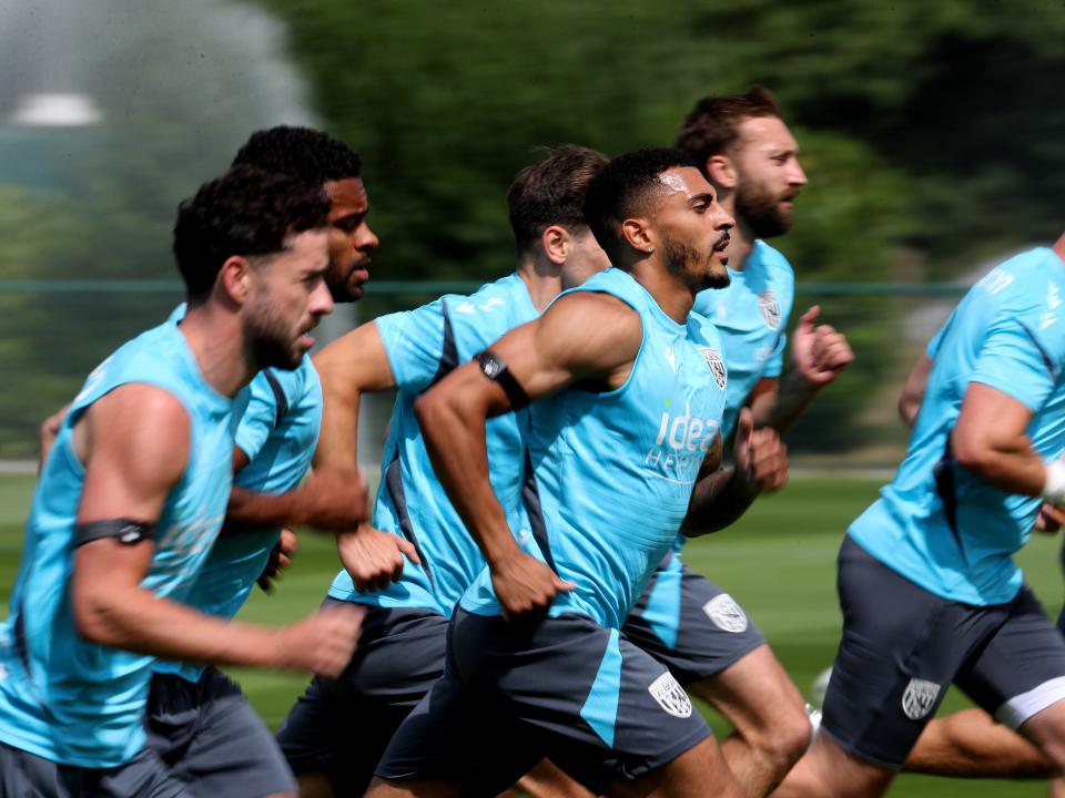 Several Albion players running during a training session
