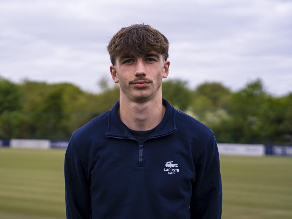 A photo of Albion youngster Alfie Maughan standing in front of the Albion training pitches