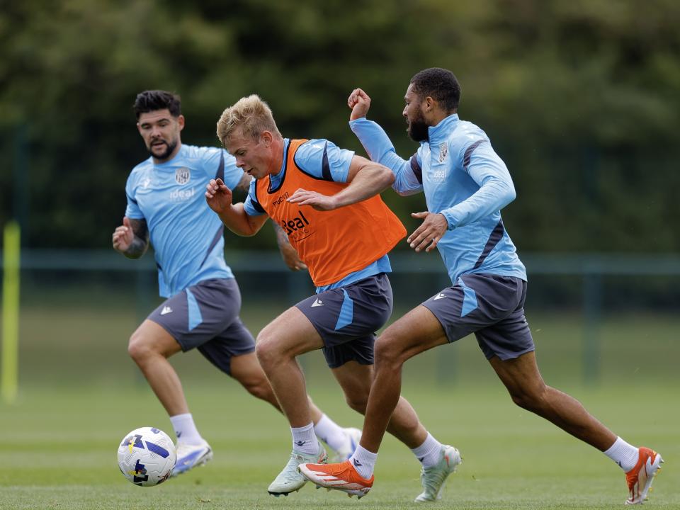 Aune Heggebø on the ball during a training session, followed closely by Alex Mowatt and George Campbell