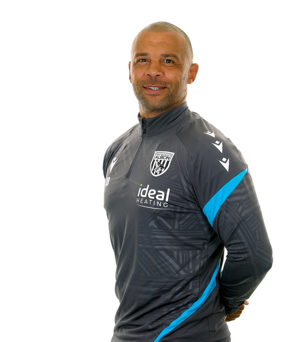 A photo of Albion Senior PDP Coach Deon Burton in the 2025/26 grey training kit