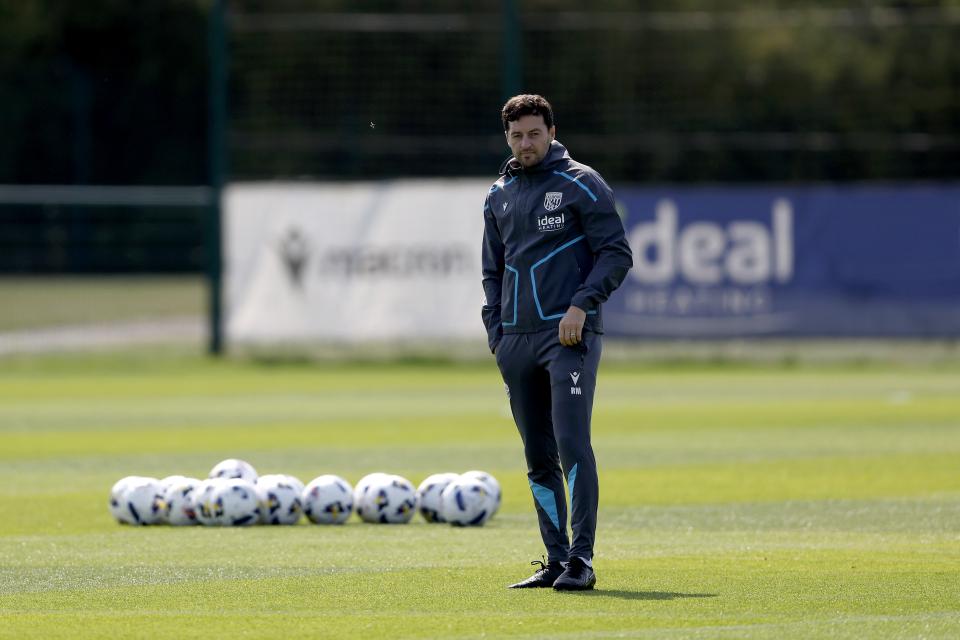 Ryan Mason stood next to several footballs on the training pitch 