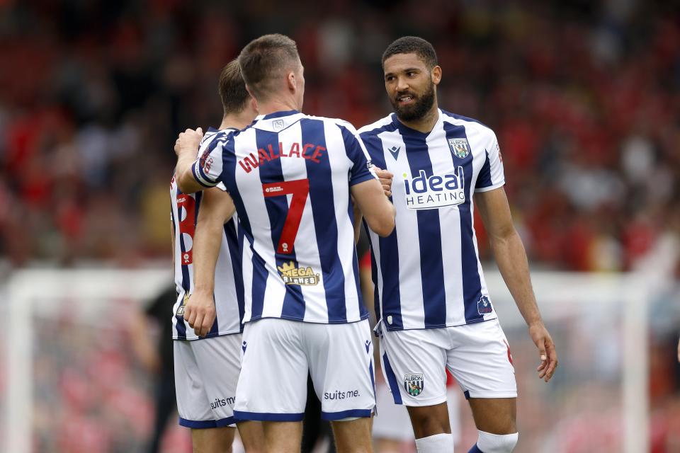 George Campbell talking to Jed Wallace while in the home kit during a game 