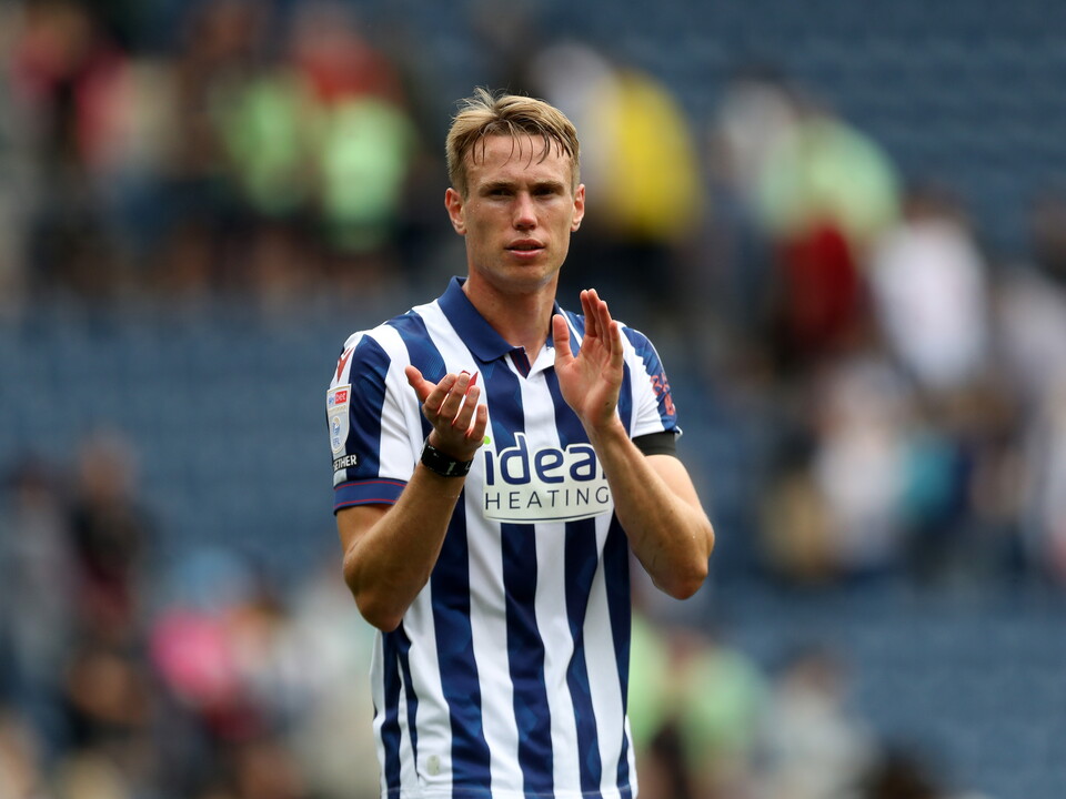 An image of Torbjorn Heggem applauding Albion supporters