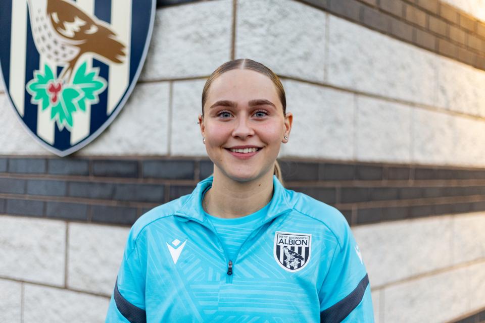 Mia Sorrentino smiling at the camera while wearing Albion gear