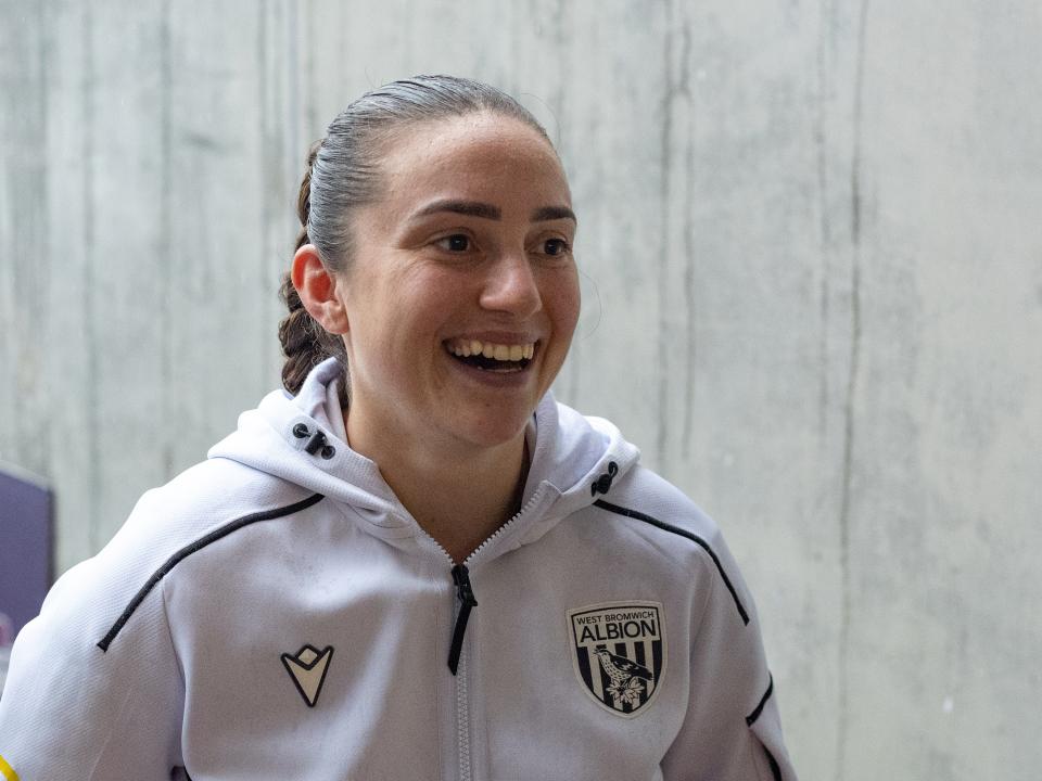 Fran Orthodoxou smiling during an interview in her WBA tracksuit 
