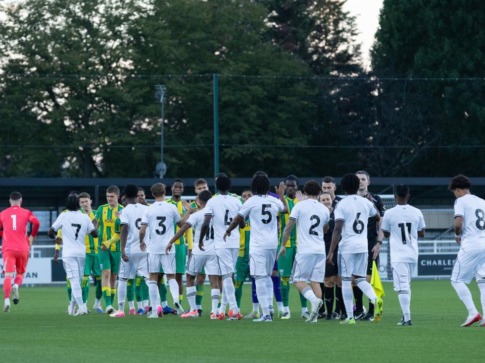 A photo of Albion PL2 players lining up against Fulham in their 2025/26 green and yellow away kit