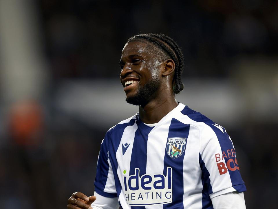 Samuel Iling-Junior smiling while wearing a home WBA kit 