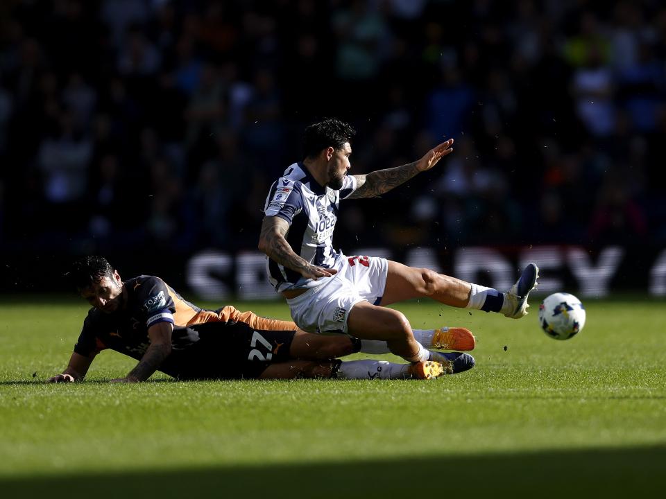 An image of Alex Mowatt tackling a Derby player