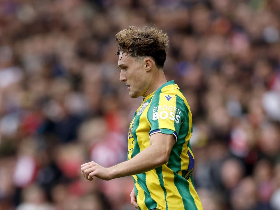 Callum Styles in action for Albion in the green and yellow kit at Stoke