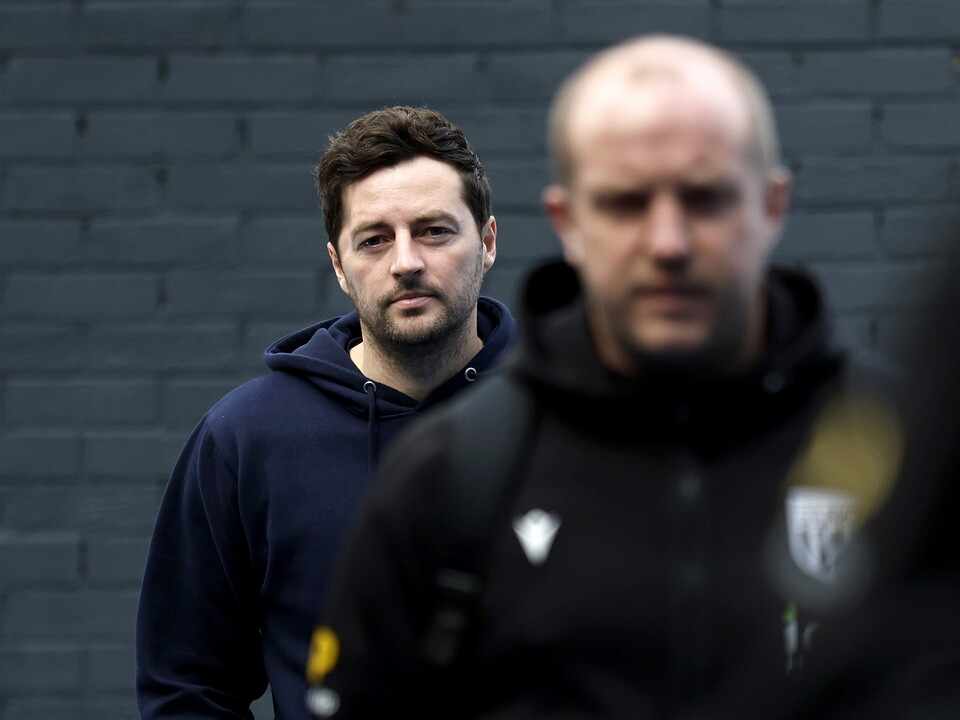 Ryan Mason looking forward while arriving ahead of a game 