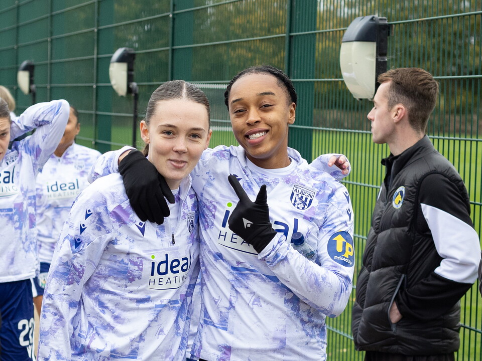 Millie Pullen and Amya Hammond-McLean smiling at the camera before warming up for a game 