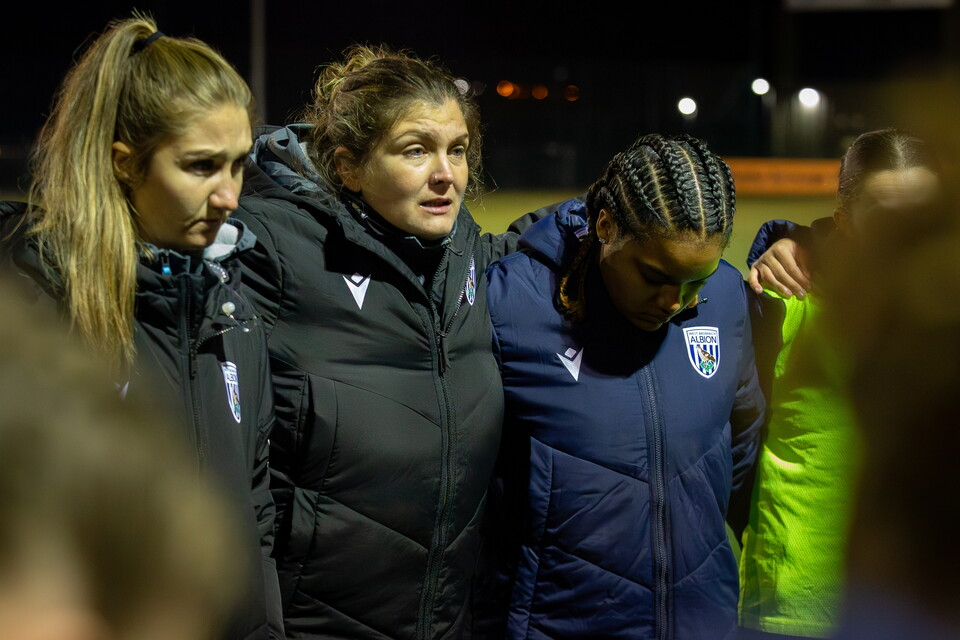 Siobhan Hodgetts-Still in a huddle with players and staff after a game 