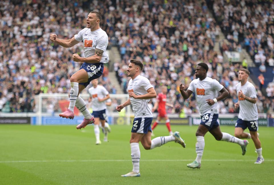Several Preston players celebrating a goal scored in their home kit 