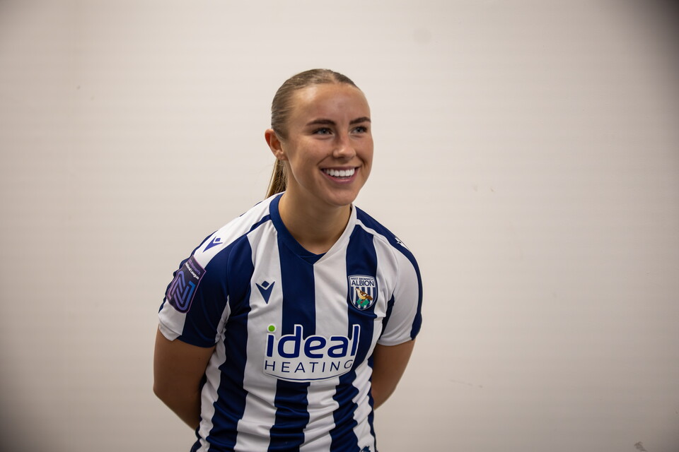 Seren Watkins smiling while being interviewed in a WBA home shirt 