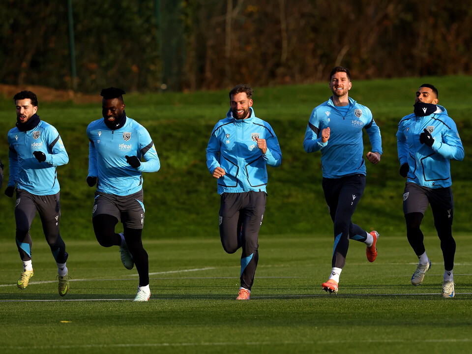 Five Baggies players running forwards in a line during a training session