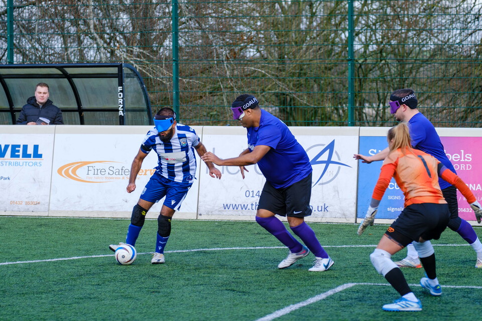 Eesa cutting in on goal, evading two defenders.