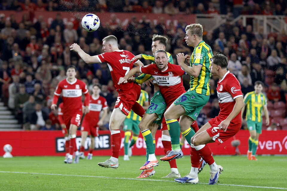 Several Boro & WBA players jumping to try and win a header 