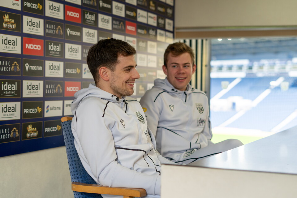 Jayson Molumby and Aune Heggebo sitting at a panel smiling