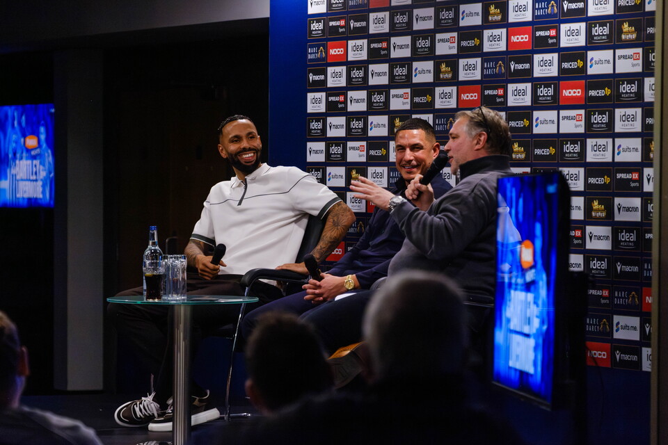 Andy Johnson speaking to Kyle Bartley and Jake Livermore as they're seated on stage