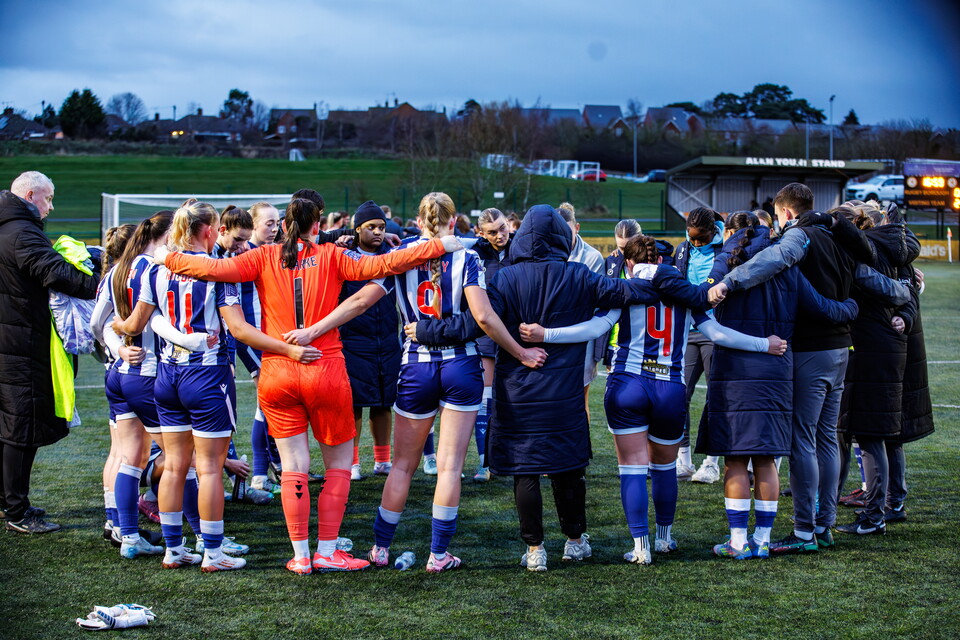 Albion Women in a team huddle.