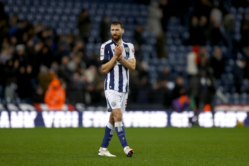 Nat Phillips applauding WBA fans while in a home shirt 