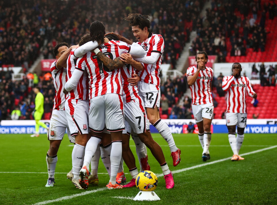 Several Stoke City players celebrate a goal scored in their home kit