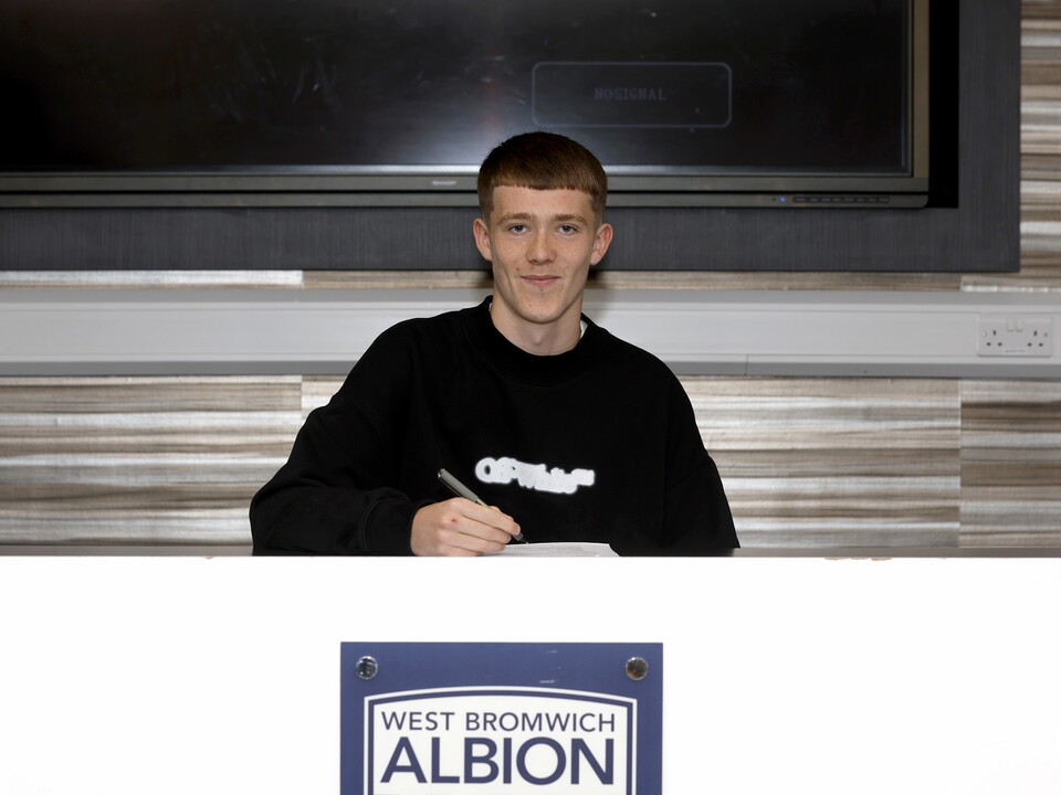 A photo of youngster Ryan Colesby signing his first pro deal