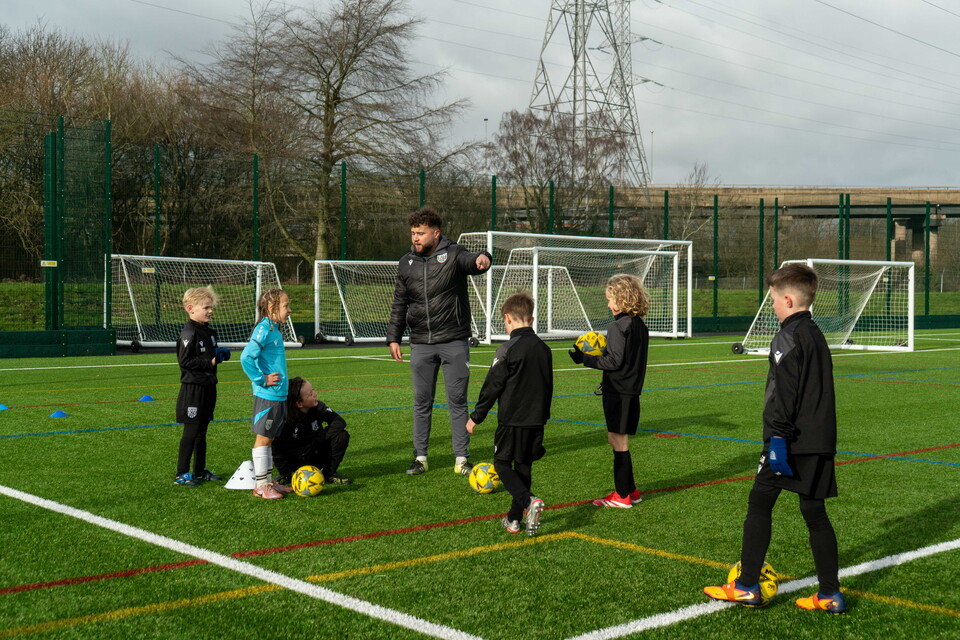 Coach giving instructions to participants